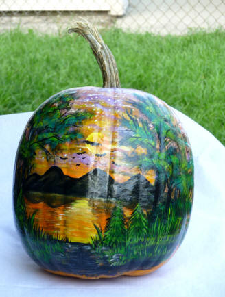 Sunset scene with mountains paintd on  a pumpkin